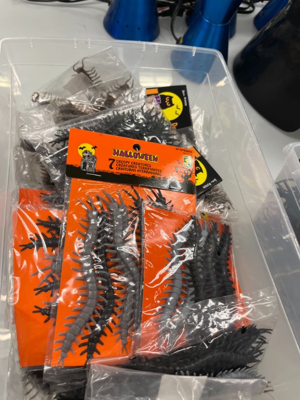 Bin of plastic centipedes