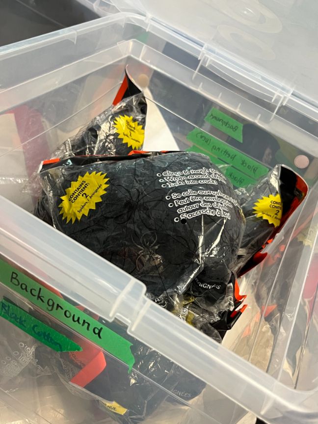 Bin of artificial spider webs, black