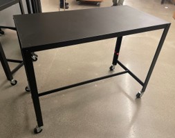 Black metal table on casters