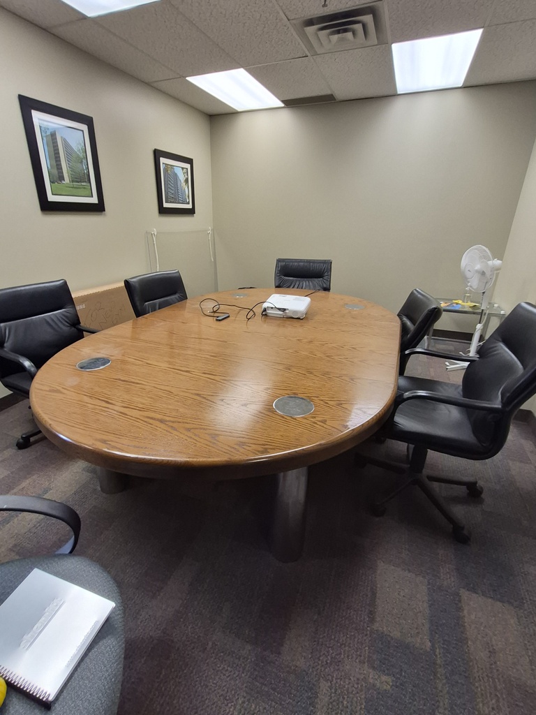 Oval, oak finish meeting table