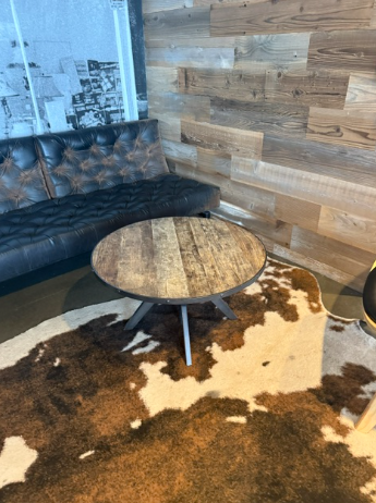 Round wood coffee table and animalprint rug
