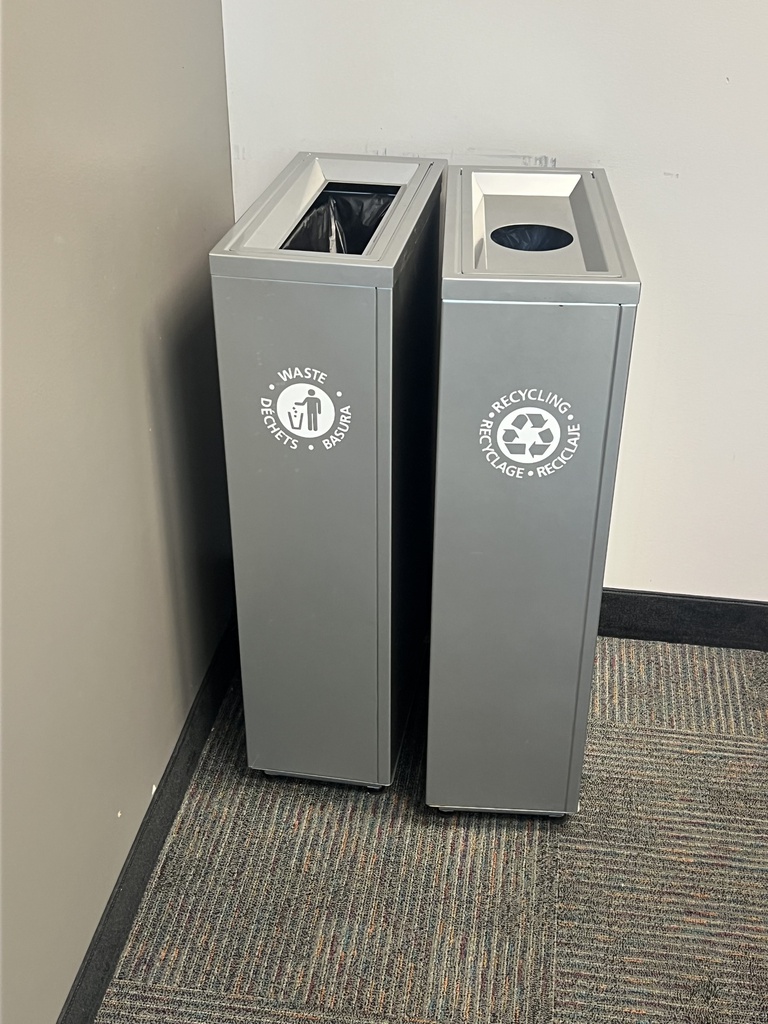 Grey metal waste bin