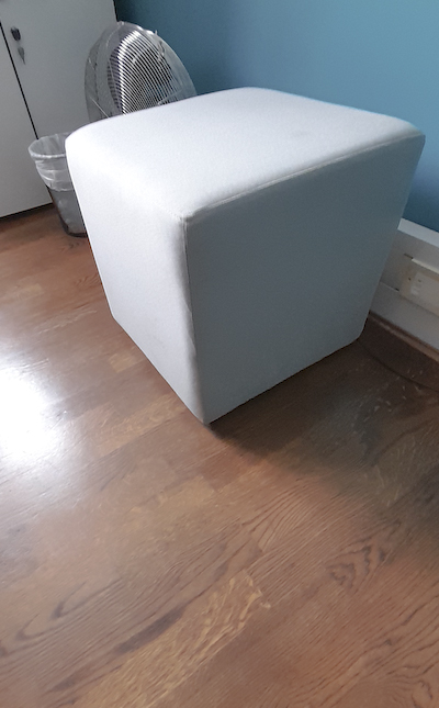 Light grey fabric pouffe seat