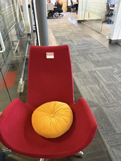 Red lounge chair by entrance