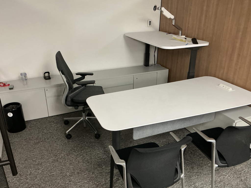 U shaped private office with 76" × 33" main desk, 58" × 30" return and 114" × 18" rear storage return; two Vitra side chairs, black fabric with chrome frame