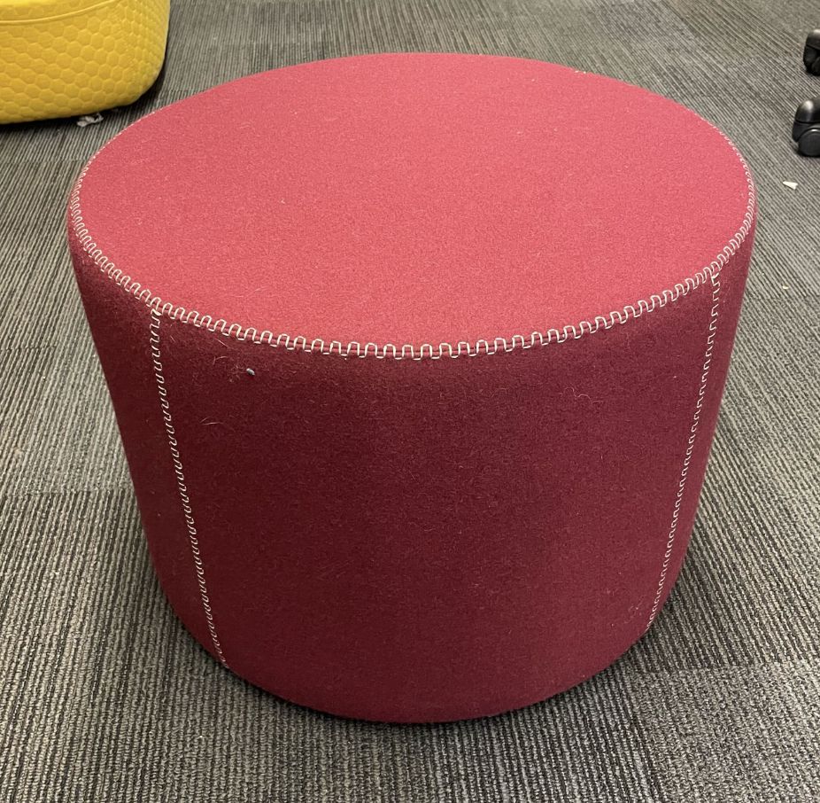 Round red ottoman on wheels