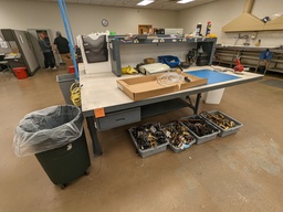 [#A3-146] work bench with larger pedestal, bolted to floor, metal base and acrylic top w/ electric shelf overhead