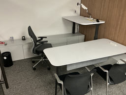 [#E8-33] U shaped private office with 76" × 33" main desk, 58" × 30" return and 114" × 18" rear storage return; two Vitra side chairs, black fabric with chrome frame
